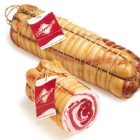 Homemade white bacon rolled with whole garlic-free rind
